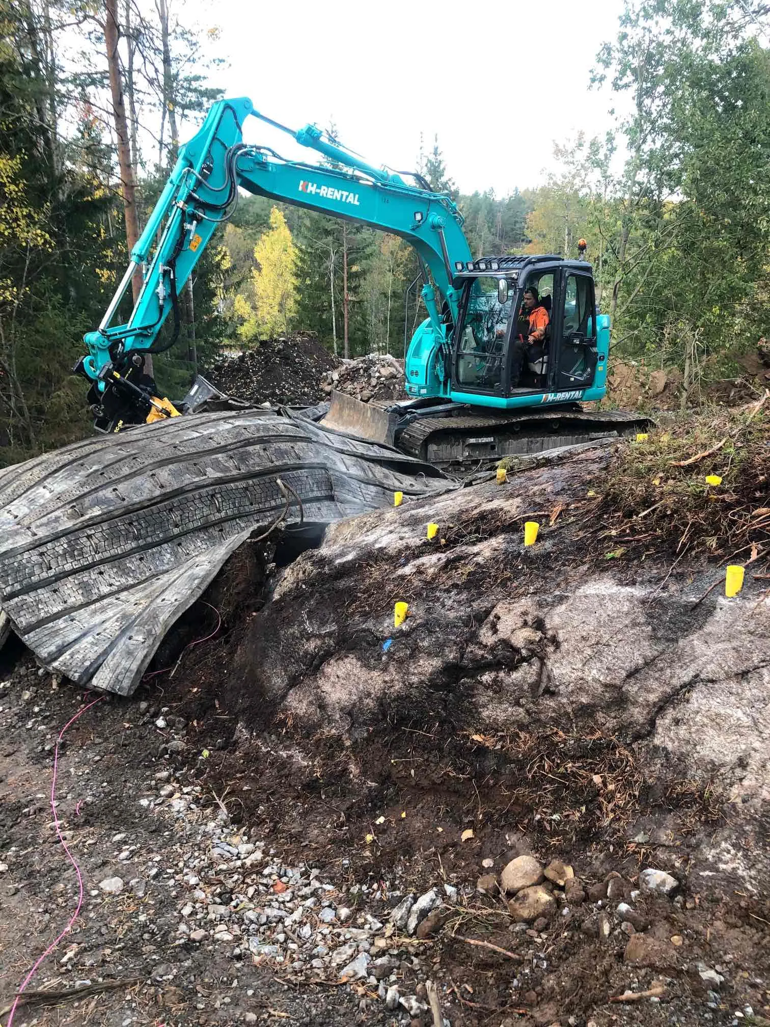 Grävmaskin vid schaktning och bortforsling av bergmassor